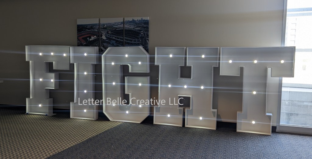 5-ft tall FIGHT marquee letters with lights, made of white foam core. Decor element at Denver Broncos' Fight Like a Bronco event at Empower Field at Mile High

Letter Belle Creative