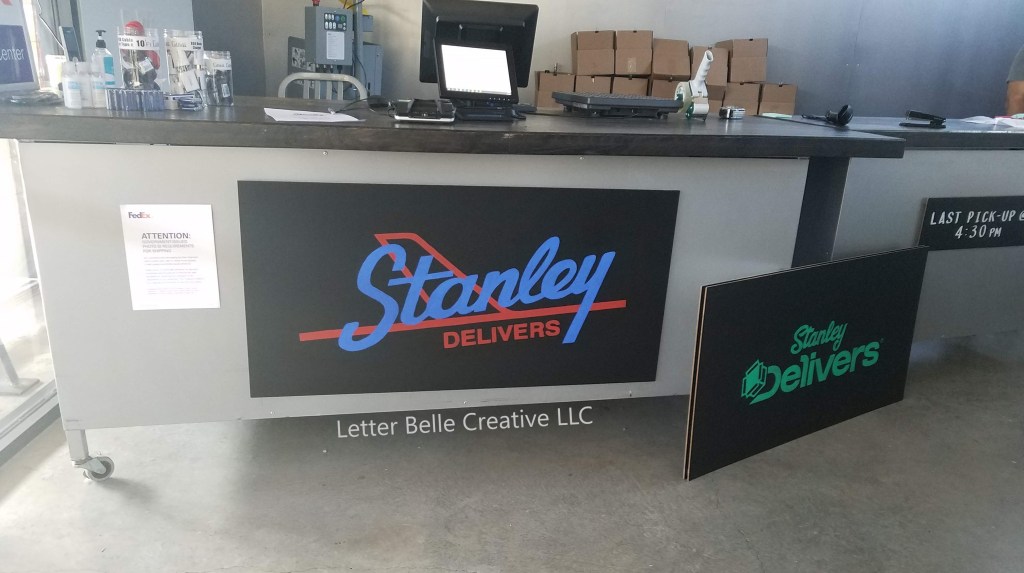 Logos for Stanley Delivers painted on large frameless chalkboards. Old logo painted in green. New logo painted in blue & red.

Letter Belle Creative