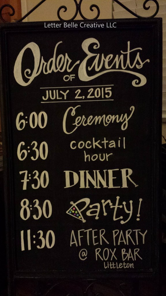 Black framed chalkboard with white hand lettering, showing the wedding's Order of Events on July 2, 2015: Ceremony, cocktail hour, dinner, party, after party

Letter Belle Creative