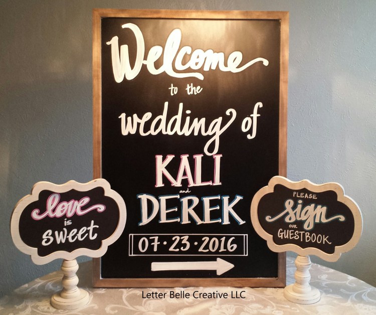 Framed chalkboard with white hand lettering: Welcome to the wedding of Kali & Derek 07.23.2016 (with arrow pointing to the right)

Letter Belle Creative
